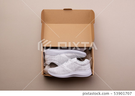 A studio shot of pair of running shoes in paper box. Flat lay. A studio shot of pair of running shoes in paper box. Flat lay. 53901707