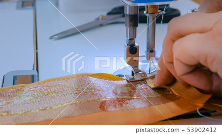Professional tailor, fashion designer sewing clothes with sewing machine 53902412