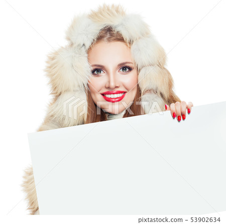 Winter woman showing white empty paper board 53902634