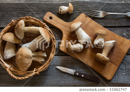 Fresh white mushrooms in basket for cooking. 53902747