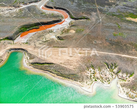 Amazing aerial view of small red water river and green water lake Baskunchak 53903575