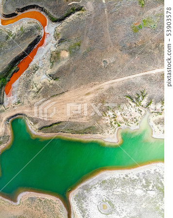 Amazing aerial view of small red water river and green water lake Baskunchak 53903578