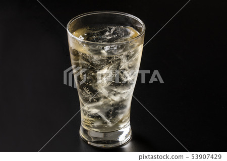 Pouring highball into glass on black background 53907429