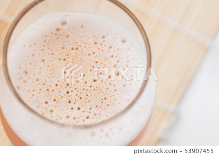 Drinking beer poured into a glass 53907455