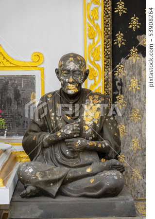 Statue of Sitting Monk Splattered With Paint Statue of Sitting Monk Splattered With Paint 53908264