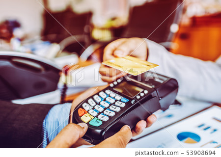 Hand of business man customer paying with NFC 53908694
