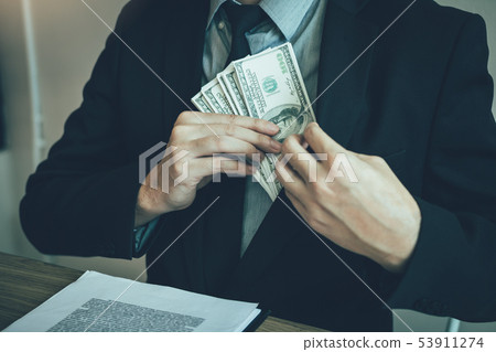 Businessman putting stack of money bills in his 53911274
