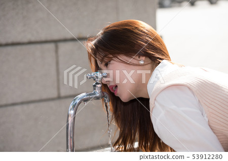 Women with tap water Women with tap water 53912280