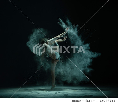 Anonymous dancer throwing sand and lifting leg 53912543