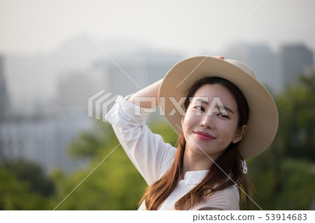 A woman in a hat A woman in a hat 53914683