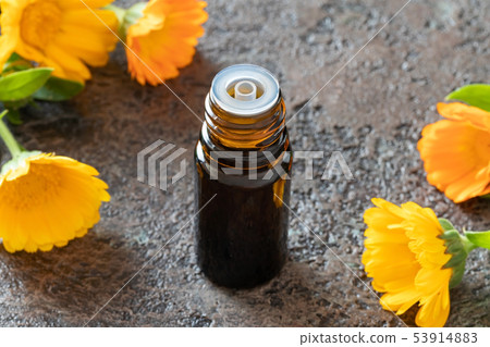 A bottle of calendula essential oil with calendula A bottle of calendula essential oil with calendula 53914883