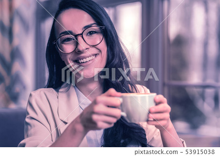 Cheerful delighted young woman visiting a cafeteria 53915038
