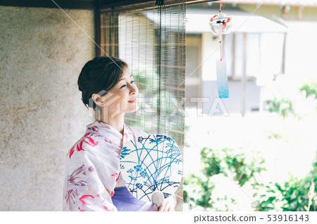 A woman in a yukata that cools on the veranda 53916143