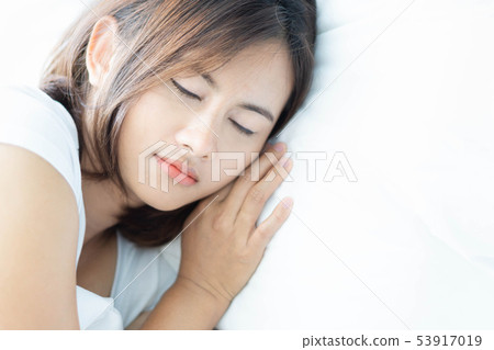 Closeup young woman sleeping with happy face Closeup young woman sleeping with happy face 53917019