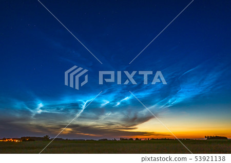 Landscape of night shining noctilucent clouds in the night sky 53921138