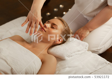 Gentle master in white uniform choosing special dots on the face Gentle master in white uniform choosing special dots on the face 53921172