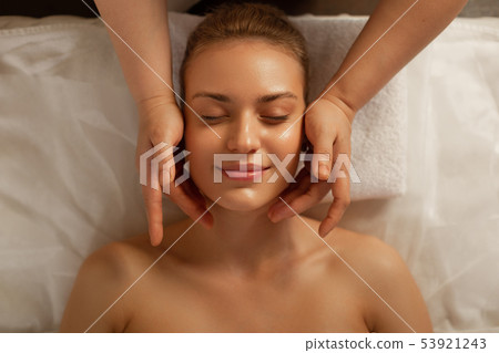 Beaming flawless woman with gentle face showing pleasant smile Beaming flawless woman with gentle face showing pleasant smile 53921243