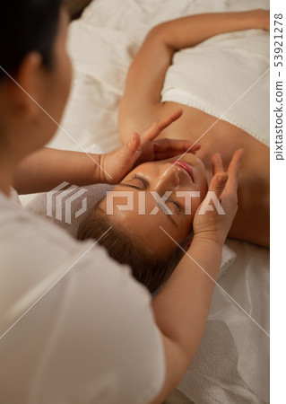 Professional master using special movements during face massage Professional master using special movements during face massage 53921278