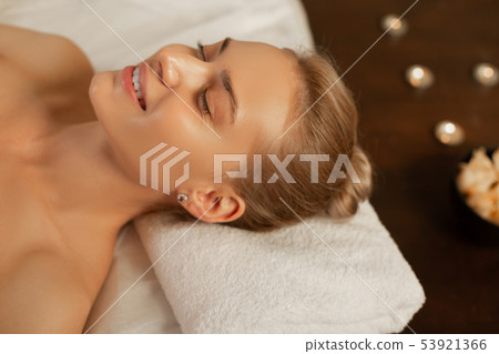 Smiling attractive blonde lady being satisfied with relaxing procedure Smiling attractive blonde lady being satisfied with relaxing procedure 53921366