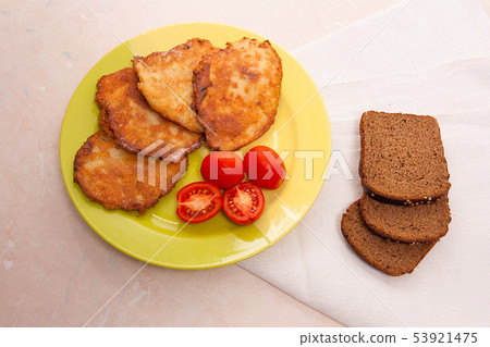 Potato pancakes with meat and tomatoes on green Potato pancakes with meat and tomatoes on green 53921475