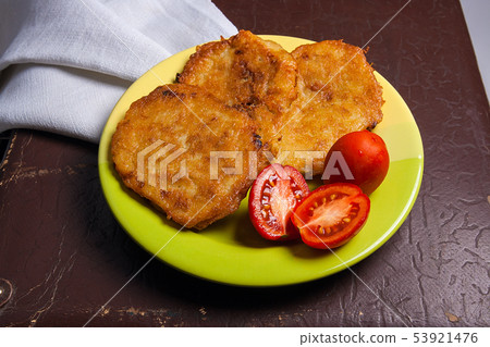 Potato pancakes with meat and tomatoes on green Potato pancakes with meat and tomatoes on green 53921476