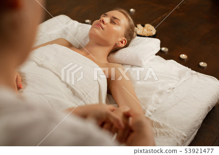 Flawless good-looking lady resting on a daybed in massage cabinet Flawless good-looking lady resting on a daybed in massage cabinet 53921477