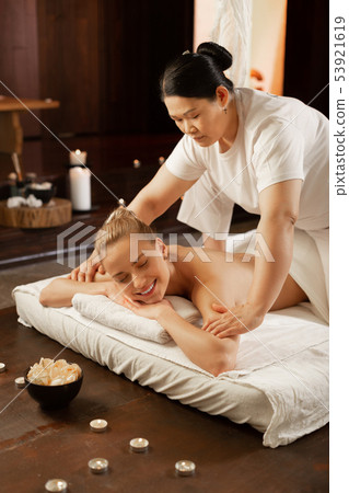Focused Asian dark-haired woman being an experienced massage master Focused Asian dark-haired woman being an experienced massage master 53921619