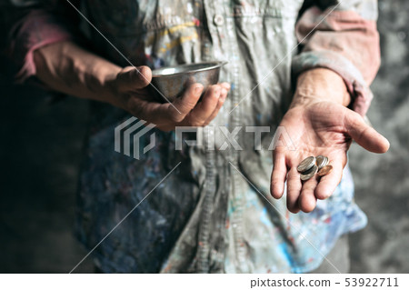 Male beggar hands seeking money on the wooden floor at public path way Male beggar hands seeking money on the wooden floor at public path way 53922711