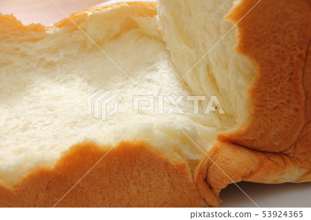Square shaped bread broken by hand. 53924365