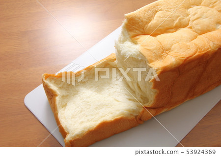 Square shaped bread broken by hand. Square shaped bread broken by hand. 53924369