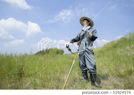 A man using a mini fan at field work A man using a mini fan at field work 53924574