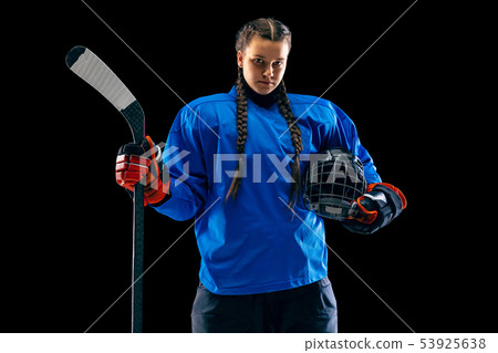 Young female hockey player with the stick isolated on black background 53925638