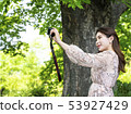 A young female model enjoying a self in the forest of Namsan Park in Seoul 53927429
