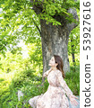 Young female model drinking fresh air under the zelkova tree in Namsan Park in Seoul 53927616