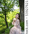 A young female model enjoying gifts in the forest of Namsan Park in Seoul 53927621
