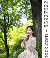A young female model enjoying gifts in the forest of Namsan Park in Seoul 53927622