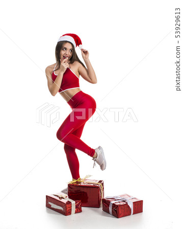 funny sporty woman with new year and christmas gifts isolated on white background. X-mas fun and 53929613