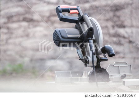 Mitre Saw on the background gray wall Mitre Saw on the background gray wall 53930567