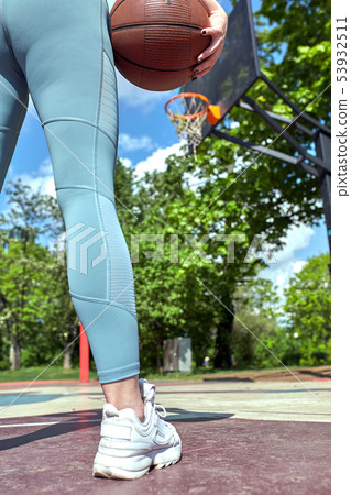 Beautiful sexy fitness girl in black sport wear with perfect body with basket ball at basketball Beautiful sexy fitness girl in black sport wear with perfect body with basket ball at basketball 53932511