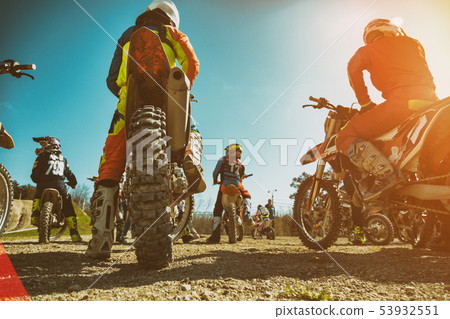 Dirtbike. Team Motocross on bike motorcycle is start road. rear view Dirtbike. Team Motocross on bike motorcycle is start road. rear view 53932551