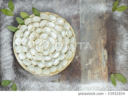 Meat dumplings - russian pelmeni on wooden background 53932834