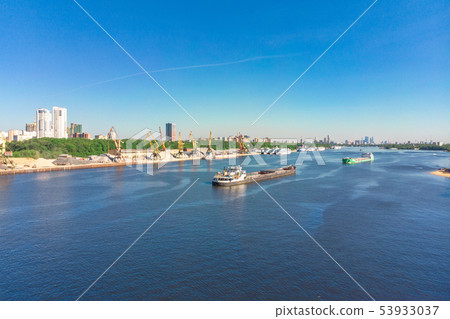 Scenic view of the city by the river with ships sailing on it. Concept clean city, life in the city Scenic view of the city by the river with ships sailing on it. Concept clean city, life in the city 53933037