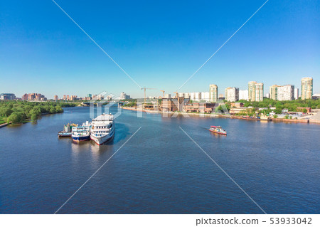 Scenic view of the city by the river with ships sailing on it. Concept clean city, life in the city Scenic view of the city by the river with ships sailing on it. Concept clean city, life in the city 53933042