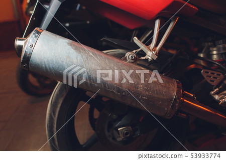 rear view of classical motorcycle pair of exhaust chrome pipes selective focus. 53933774
