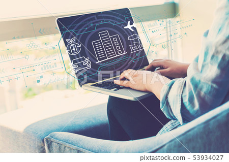 Smart city concept with woman using laptop Smart city concept with woman using laptop 53934027