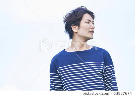 Young man blue sky 53937674