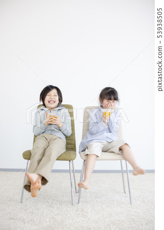 孩子坐在椅子上,喝果汁 孩子坐在椅子上,喝果汁 53938505