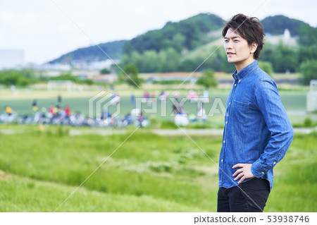 Young man blue sky park 53938746