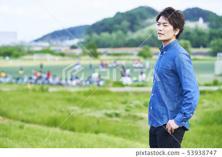 Young man blue sky park 53938747