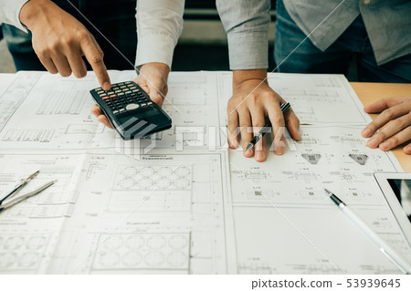 Architects or engineering working with blueprints 53939645